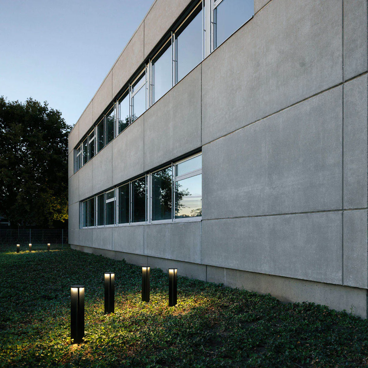 Pollerleuchten für außen im Garten hinter einem Gebäude